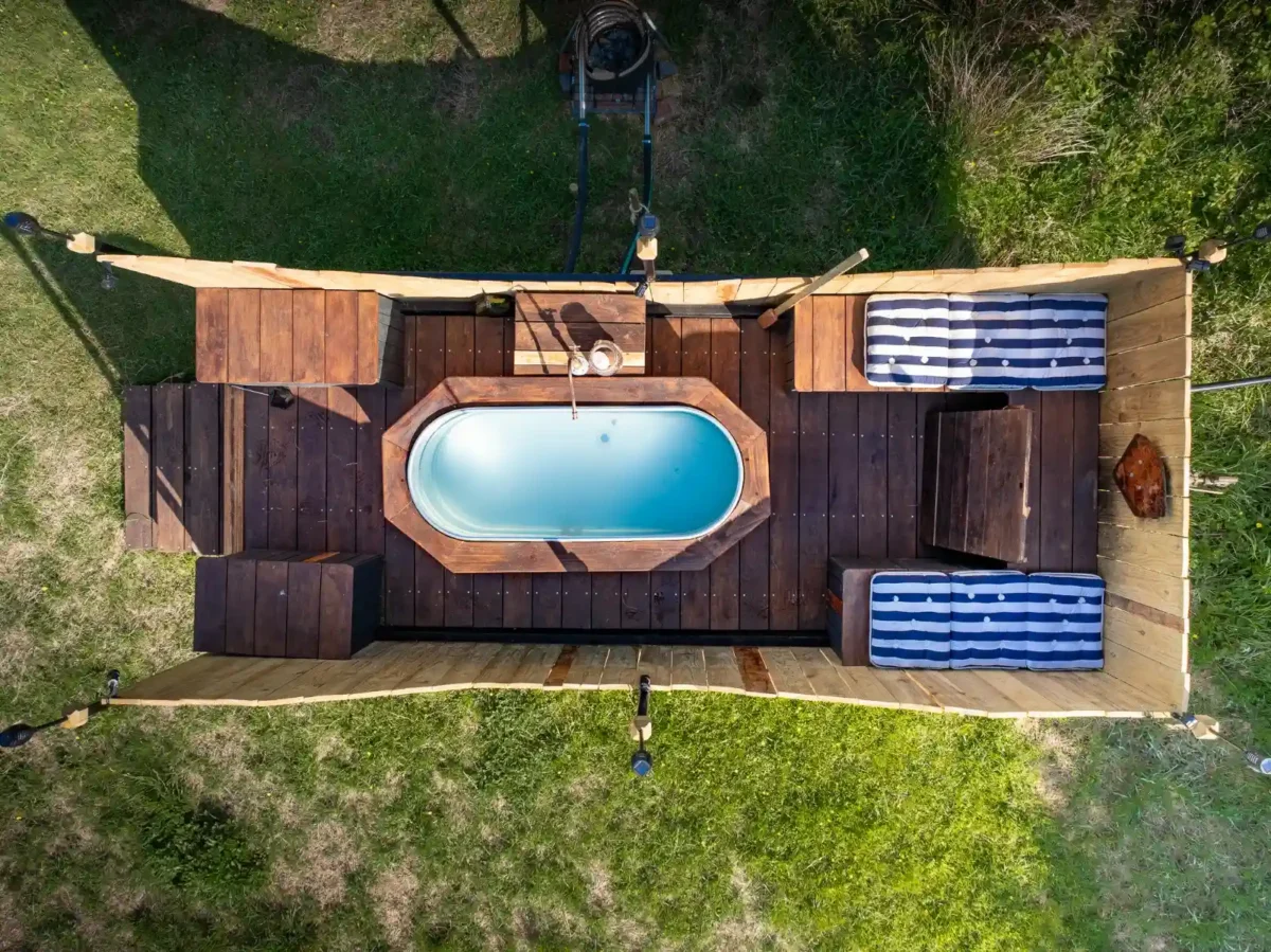 Aerial view of a private wood-fired hot tub deck at a secluded glamping cabin in East Sussex